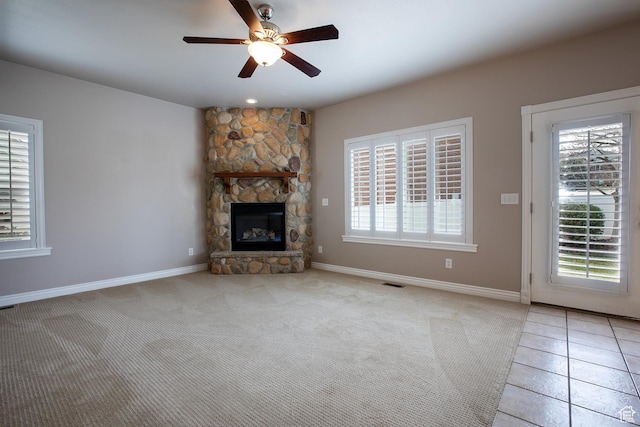 2783 S Irene Dr E, Bountiful, UT 84010 - unfurnished living room featuring light tile patterned floors, visible vents, a ceiling fan, light carpet, and a fireplace