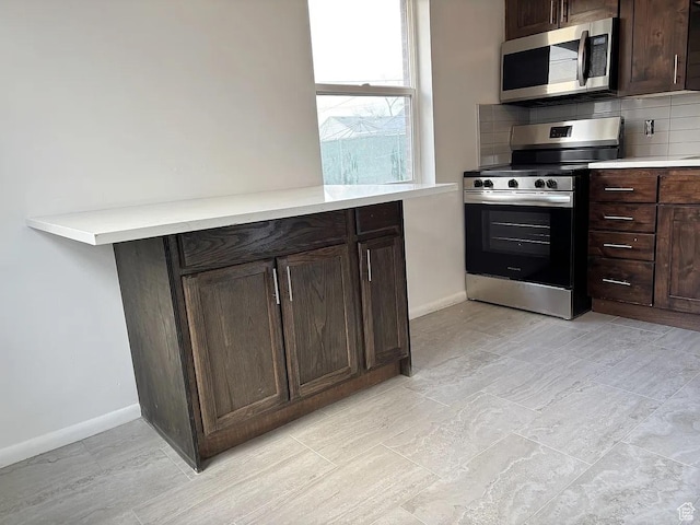793 N 1200 W, Salt Lake City, UT 84116 - kitchen with stainless steel appliances, dark brown cabinets, light countertops, and decorative backsplash