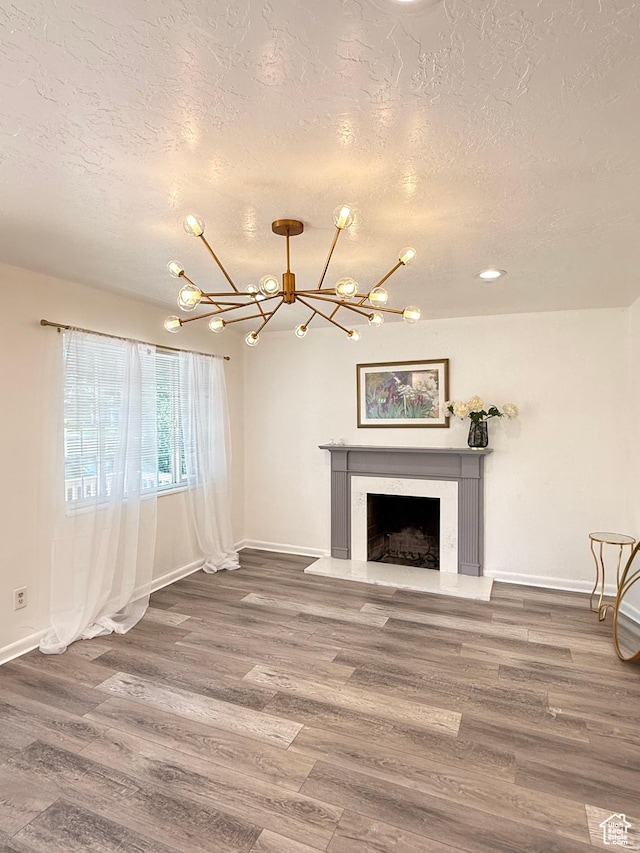 793 N 1200 W, Salt Lake City, UT 84116 - unfurnished living room with a textured ceiling, a chandelier, wood finished floors, and a premium fireplace