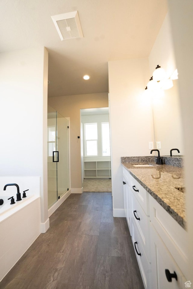 573 N 510 E Unit 20, Smithfield, UT 84335 - bathroom with a stall shower, a garden tub, wood finished floors, vanity, and recessed lighting