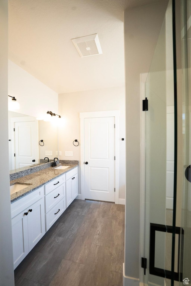 573 N 510 E Unit 20, Smithfield, UT 84335 - full bath featuring double vanity, wood finished floors, and an enclosed shower