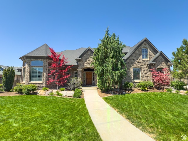 11278 S Portobello Rd W, South Jordan, UT 84095 - french country home with brick siding and a front lawn