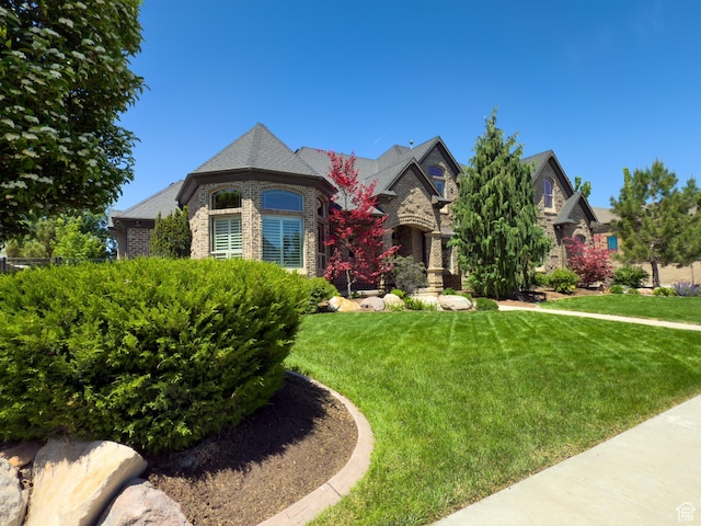 11278 S Portobello Rd W, South Jordan, UT 84095 - french country home with a front yard and brick siding
