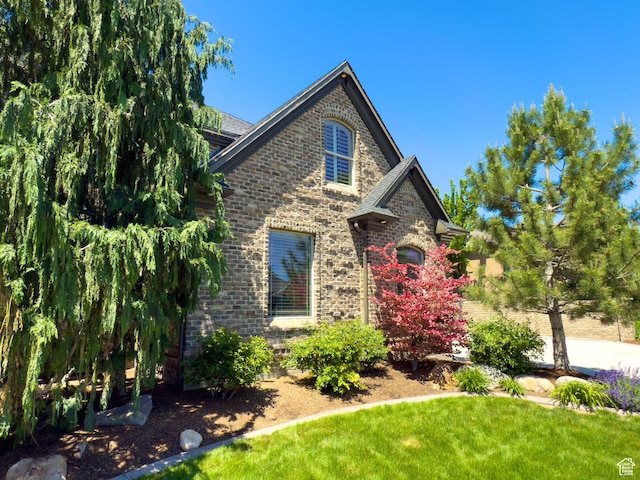 11278 S Portobello Rd W, South Jordan, UT 84095 - view of front of property with a front yard and brick siding