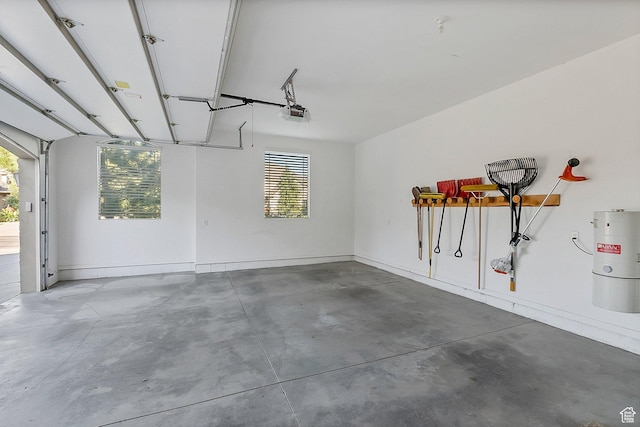 garage featuring electric water heater and a garage door opener