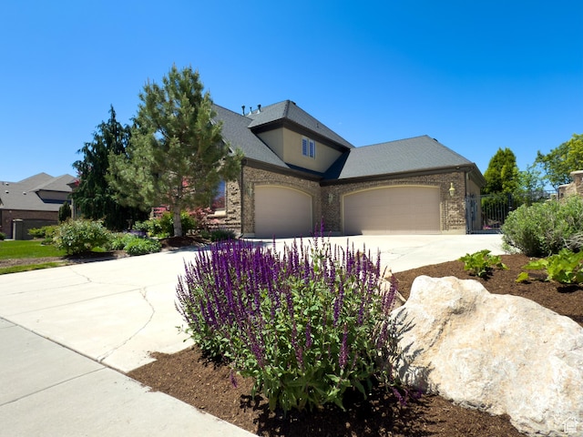 11278 S Portobello Rd W, South Jordan, UT 84095 - view of front of house featuring a garage, driveway, and brick siding