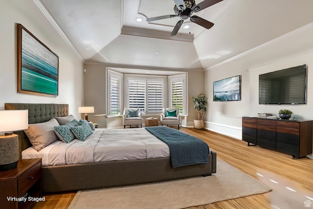 bedroom featuring ceiling fan, vaulted ceiling, wood-type flooring, and ornamental molding