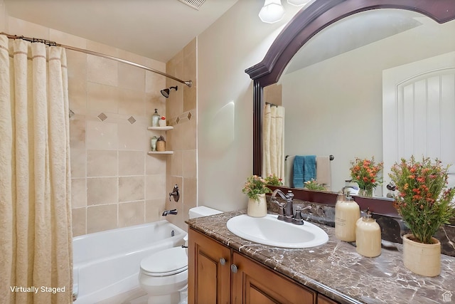 full bathroom featuring toilet, vanity, and shower / tub combo