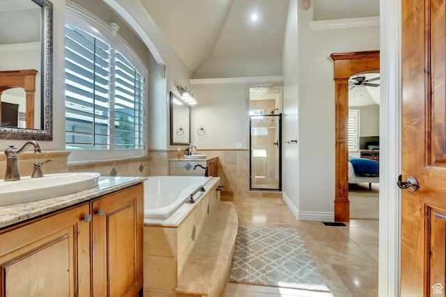 bathroom featuring lofted ceiling, independent shower and bath, crown molding, tile patterned floors, and vanity