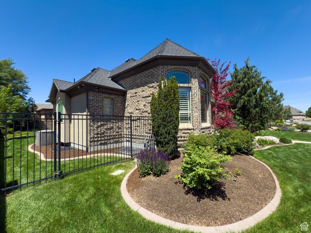 11278 S Portobello Rd W, South Jordan, UT 84095 - view of home's exterior with brick siding and a shingled roof