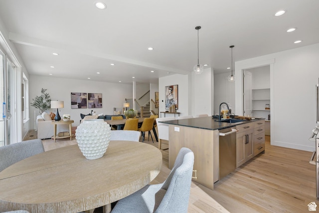 dining room with sink and light hardwood / wood-style flooring