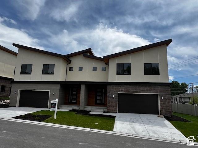 contemporary home featuring a front lawn and a garage