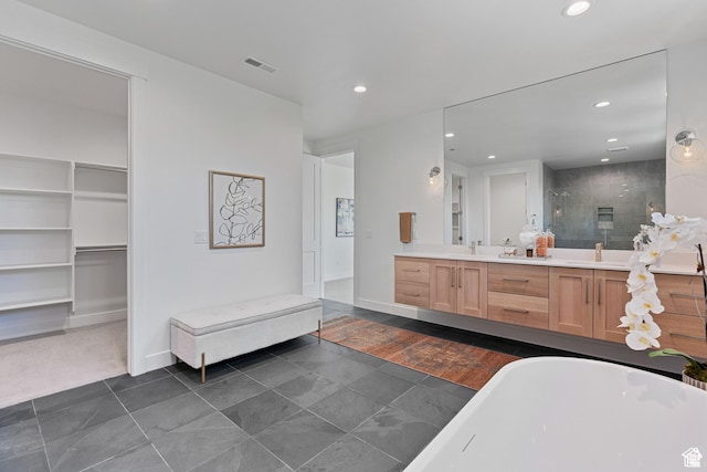 bathroom with tile patterned floors, vanity, and independent shower and bath