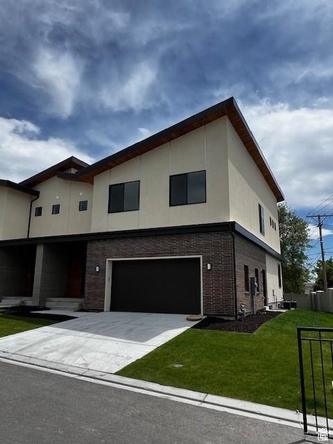 modern home featuring a garage and a front yard