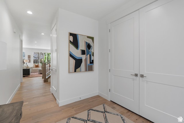 corridor with light hardwood / wood-style flooring