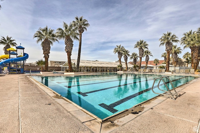 view of pool featuring a patio area and a water slide