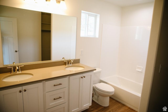 bathroom with hardwood / wood-style floors, vanity, and toilet