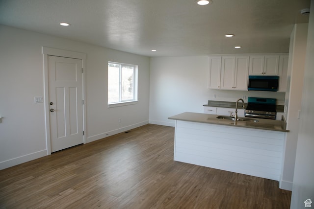 kitchen with white cabinetry, stainless steel electric range oven, dark wood-type flooring, and sink