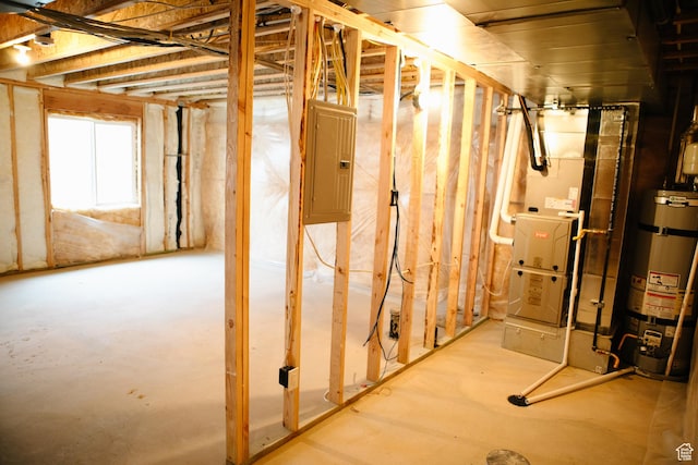 basement with electric panel and water heater