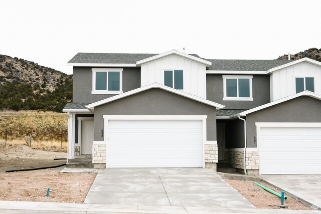 view of front of house featuring a mountain view and a garage