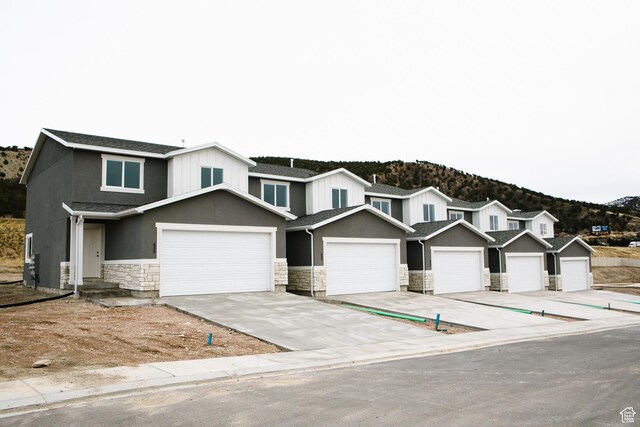 view of front of property featuring a mountain view and a garage