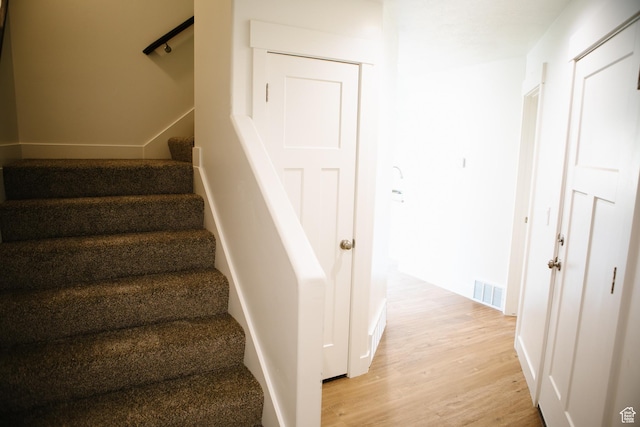 staircase featuring wood-type flooring
