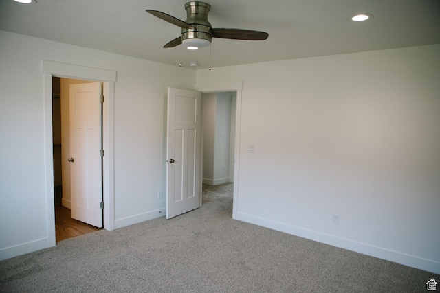 unfurnished bedroom featuring ceiling fan and light carpet