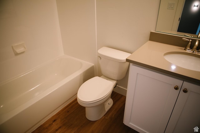 full bathroom with shower / bathing tub combination, wood-type flooring, vanity, and toilet