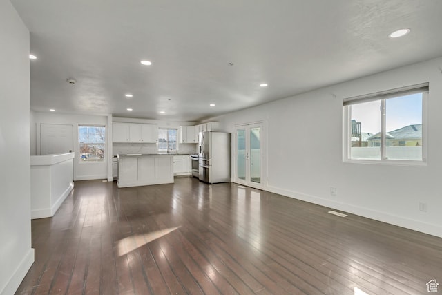 12756 S Diamond Back Dr W, Riverton, UT 84096 - unfurnished living room featuring dark hardwood / wood-style floors and sink