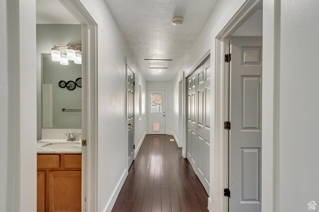 12756 S Diamond Back Dr W, Riverton, UT 84096 - hallway featuring dark hardwood / wood-style flooring, sink, and a textured ceiling