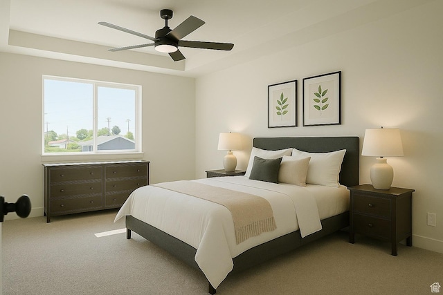 bedroom featuring carpet flooring, a ceiling fan, and a raised ceiling