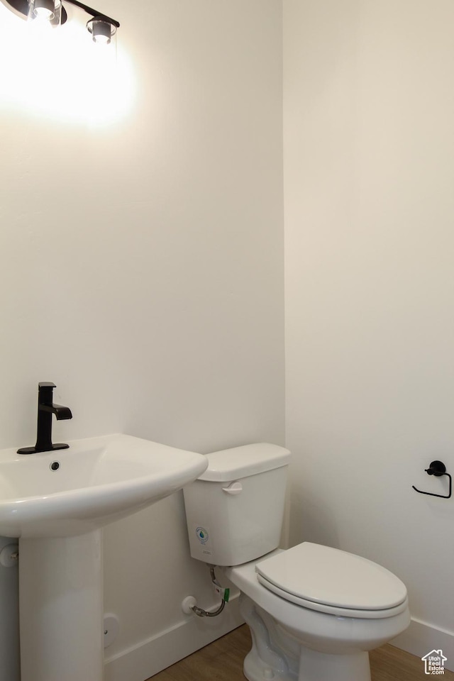 626 E 2450 N, North Logan, UT 84341 - half bath with toilet, baseboards, wood finished floors, and a sink