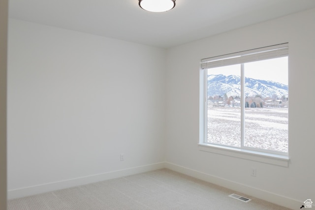 626 E 2450 N, North Logan, UT 84341 - unfurnished room with light colored carpet, baseboards, and a mountain view