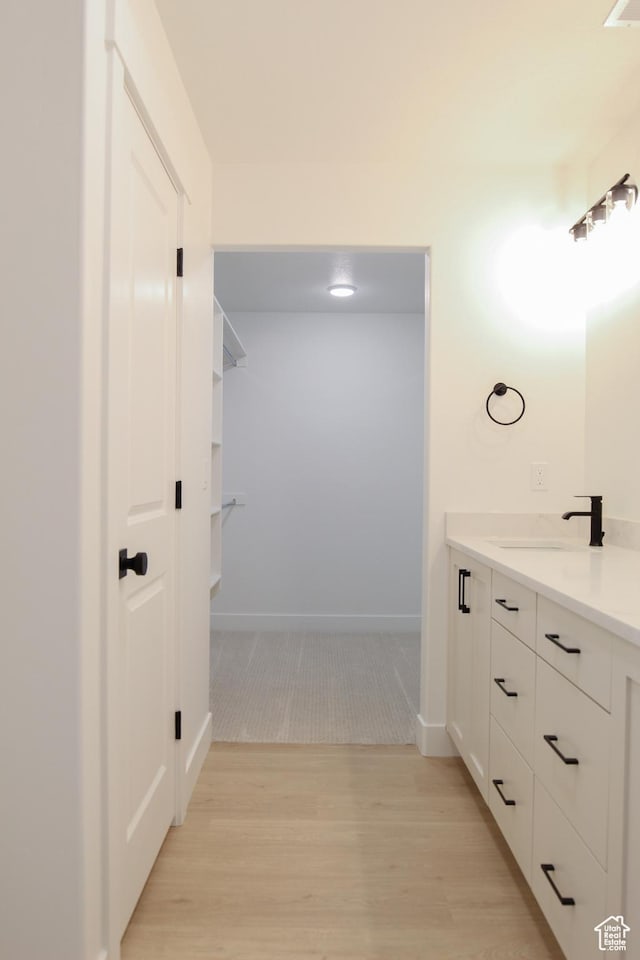 626 E 2450 N, North Logan, UT 84341 - bathroom featuring wood finished floors, vanity, and baseboards