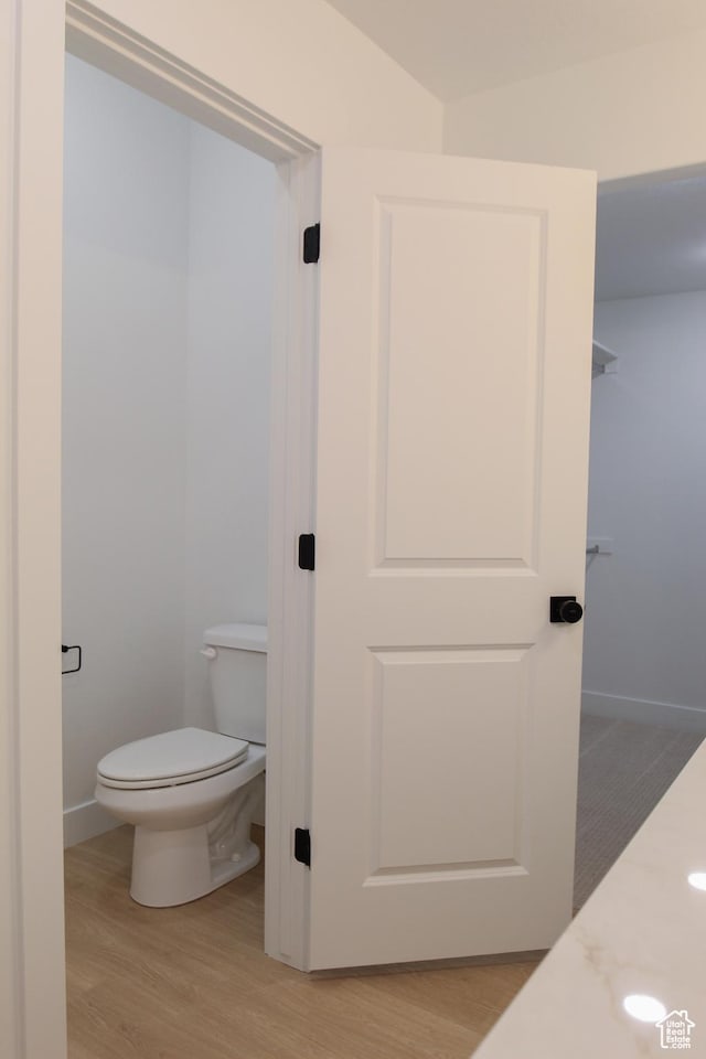 626 E 2450 N, North Logan, UT 84341 - bathroom with wood finished floors, toilet, and baseboards