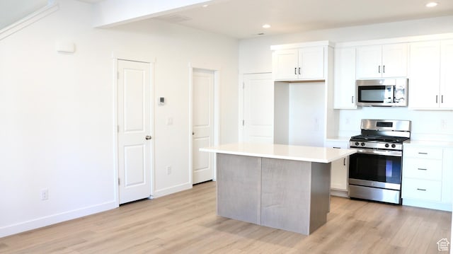 11199 S Rummy Way Unit 319, South Jordan, UT 84009 - kitchen with appliances with stainless steel finishes, a center island, light hardwood / wood-style flooring, and white cabinetry