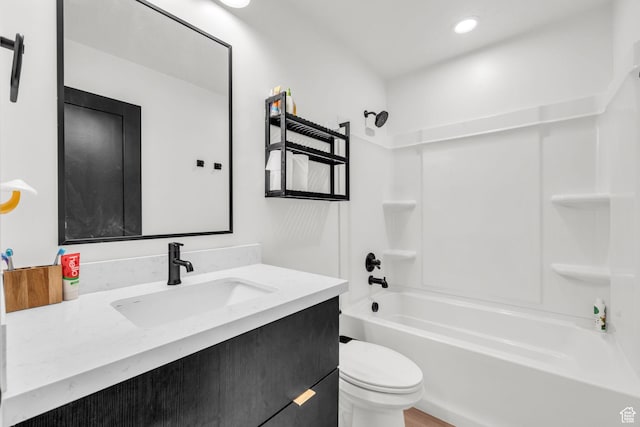 bathroom with vanity, toilet, tub / shower combination, and recessed lighting