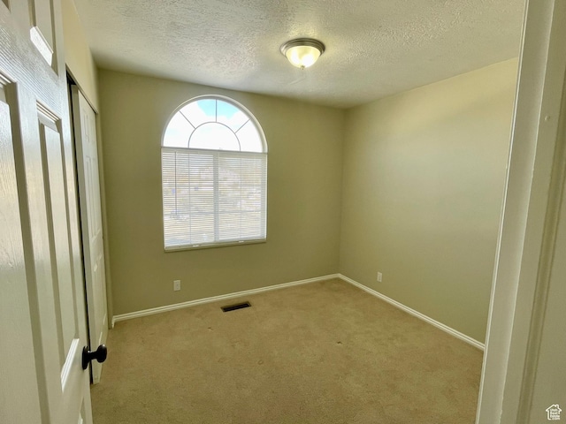 1668 N Lewis And Clark Dr, Centerville, UT 84014 - unfurnished bedroom with baseboards, a textured ceiling, visible vents, and carpet flooring