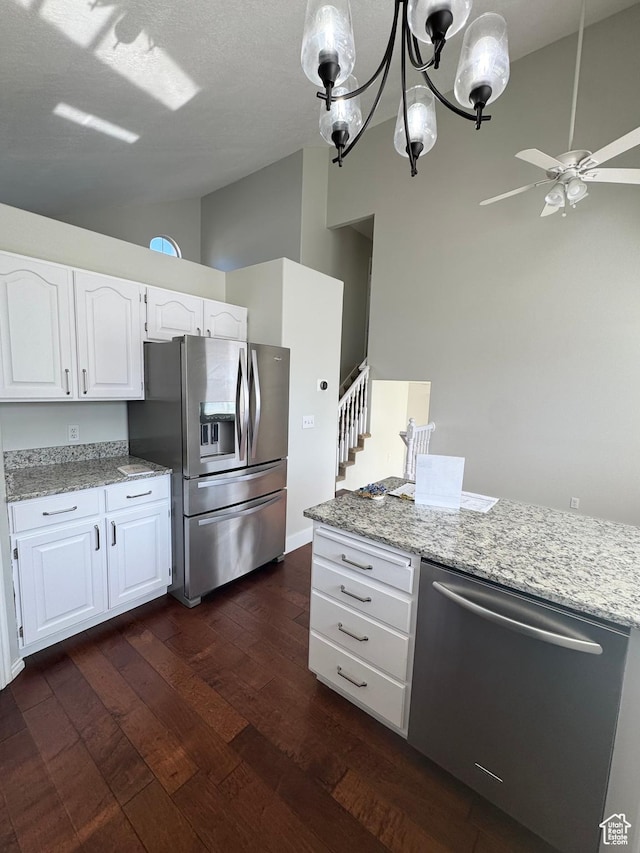 1668 N Lewis And Clark Dr, Centerville, UT 84014 - kitchen featuring white cabinets, lofted ceiling, dark wood-style floors, appliances with stainless steel finishes, and light stone countertops