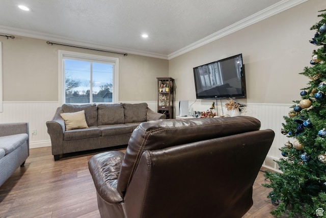 living room featuring crown molding, hardwood / wood-style floors, and a textured ceiling