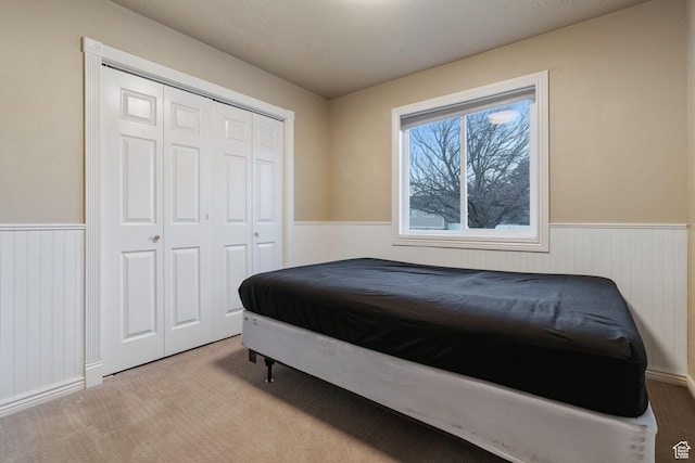 carpeted bedroom with a closet