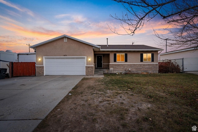single story home with a lawn and a garage
