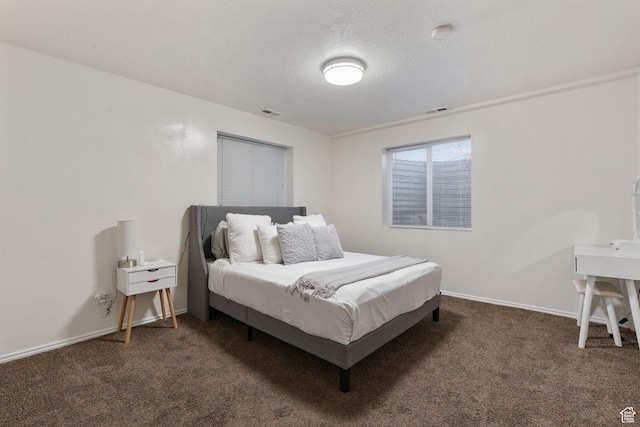 carpeted bedroom with a textured ceiling