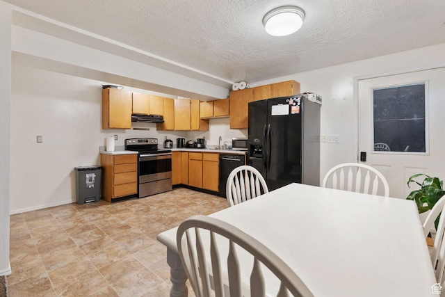 kitchen with black appliances, sink, and a textured ceiling