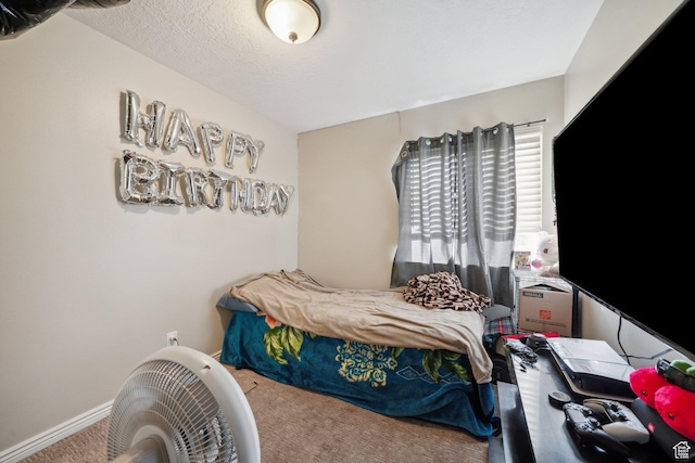 carpeted bedroom featuring a textured ceiling