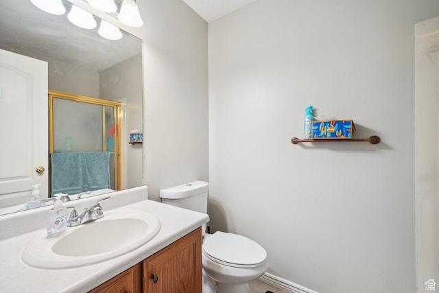 bathroom with vanity, an enclosed shower, and toilet