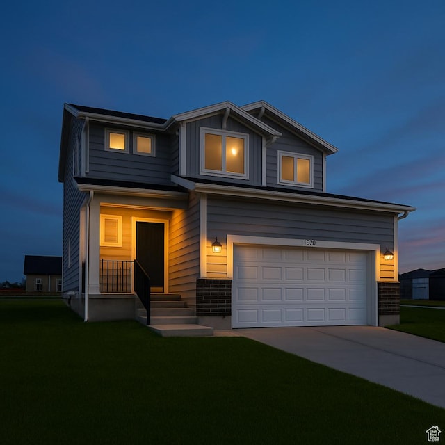 1317 N 1850 W, Clinton, UT 84015 - view of front of home featuring a garage, a front yard, driveway, and brick siding