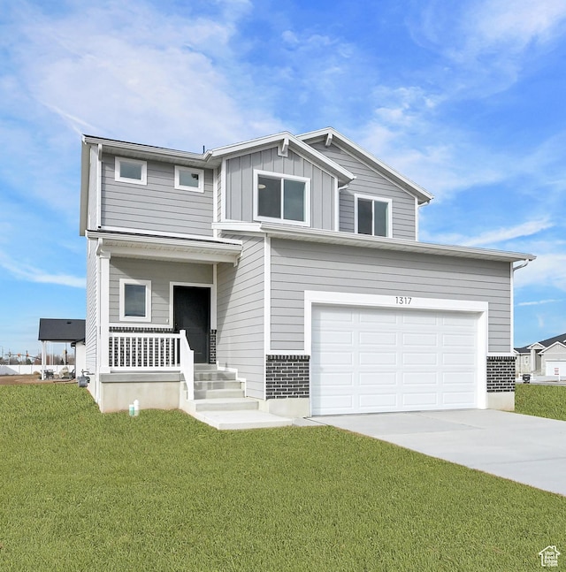 1317 N 1850 W, Clinton, UT 84015 - view of front of house featuring covered porch, concrete driveway, a front lawn, board and batten siding, and a garage