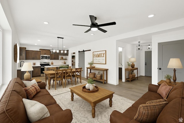1317 N 1850 W, Clinton, UT 84015 - living area with a barn door, light wood-type flooring, a ceiling fan, and recessed lighting