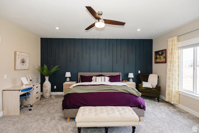 carpeted bedroom featuring multiple windows and ceiling fan